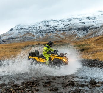 An atv enters a river in Iceland